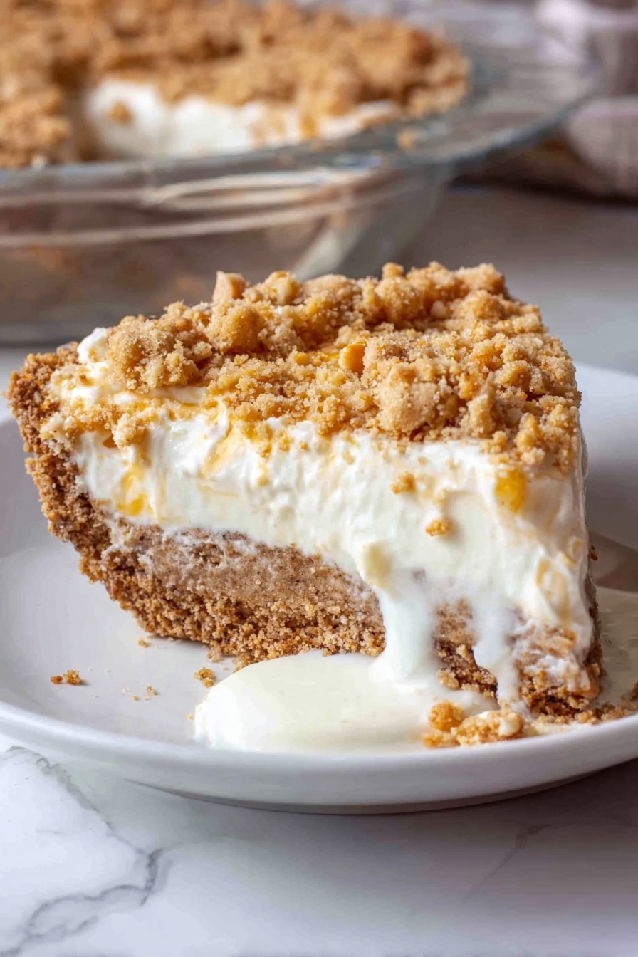 Angel Pecan Pie, light pecan pie, fluffy egg white pecan pie, maple pecan pie, holiday pecan dessert - A close-up view of a thick, light brown crust with cracks, forming the base layer in a clear glass pie dish, on a white marbled surface. On top of the crust, a fluffy, white cream layer is being spread evenly, poured from a bowl using a blue spatula held by a woman's hand. The cream is soft and smooth, with gentle folds as it lands on the crust, creating a thick second layer. The background shows a blurred maroon fabric. Photo taken with an iphone --ar 2:3 --v 7