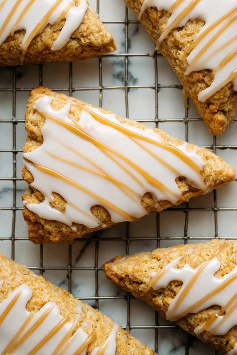 Starbucks Copycat Vegan Pumpkin Scones, vegan pumpkin scones, fall breakfast ideas, dairy-free pumpkin scones, vegan baking recipes - A close-up of a single orange-brown bar with a soft, crumbly texture showing a bite taken on one side, topped with a thick layer of smooth, creamy white icing drizzled in parallel lines across the top. The bar is held delicately by a woman's hand with a blurred white marbled background. The focus is on the detailed texture of the bar and the glossy icing with a warm, soft lighting. Photo taken with an iphone --ar 2:3 --v 7