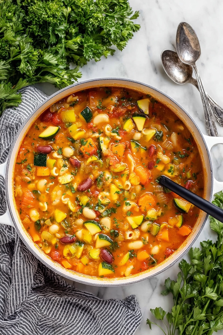 Easy Minestrone Soup, hearty vegetable soup, healthy minestrone recipe, quick vegetarian soup, comforting Italian soup - A close-up view of a white pot filled with a thick vegetable soup, showing many soft, colorful chunks. The soup has a reddish-orange broth and contains yellow squash, green zucchini slices, orange carrots, celery, red kidney beans, and small shell pasta. A dark wooden ladle lifts a scoop of soup with mixed vegetables and shells, highlighting the varied textures and colors. The pot sits on a white marbled surface with some green herbs blurred in the background, and a woman's hand holding the ladle is slightly visible. Photo taken with an iphone --ar 2:3 --v 7