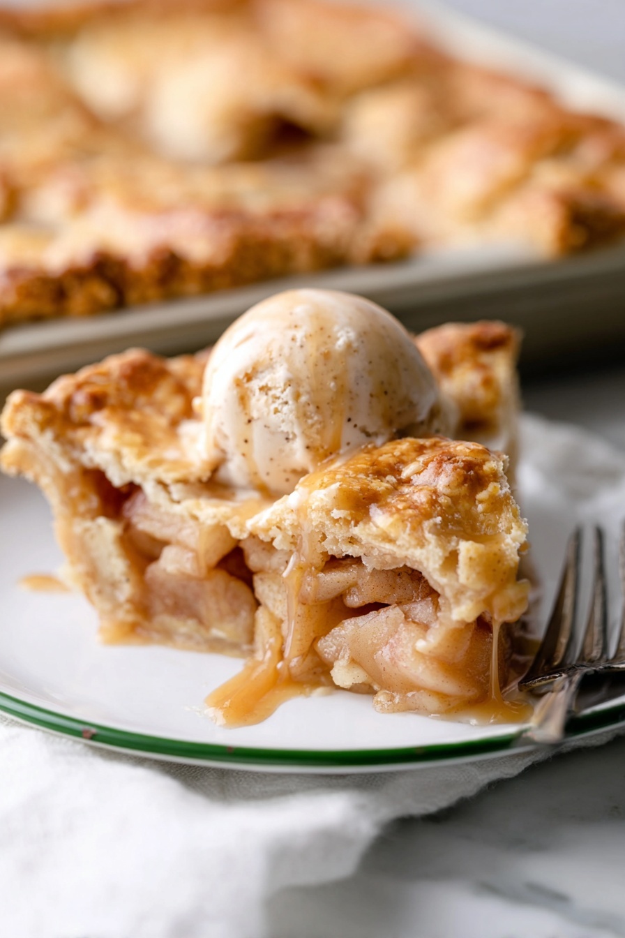Apple Slab Pie, apple slab pie recipe, fall dessert ideas, easy apple pie, sheet pan apple pie - A white plate with a green rim holds a slice of apple pie topped with a scoop of cinnamon ice cream. The pie slice has several golden, flaky layers of crust on top and bottom, filled with soft, light brown cooked apple pieces surrounded by a glossy syrup. On the ice cream, dark brown caramel sauce slowly drips down the sides. In the background, part of the remaining pie sits on a baking tray on a white marbled surface, with a silver fork nearby. photo taken with an iphone --ar 2:3 --v 7