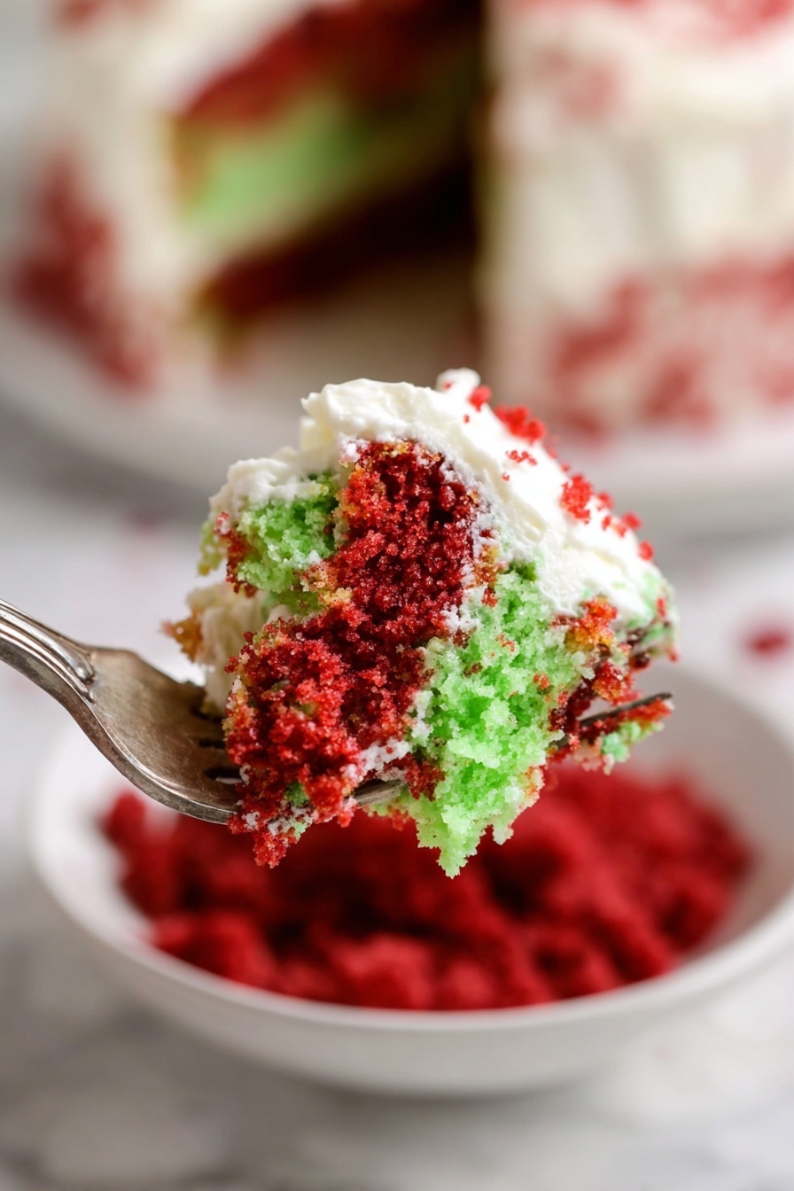 Festive Red Velvet and Green Cake Trifle, holiday dessert, Christmas cake trifle, layered festive dessert, red velvet green cake - A close-up view of a fork holding a bite of two-layer cake with bright red and light green crumb layers, topped with white creamy frosting that is slightly spread over both layers, showing a mix of crumb textures and smooth frosting. In the background, a white bowl filled with red crumbs and a white marbled surface are slightly blurred, enhancing focus on the cake piece. The layering and vivid colors make the dessert look inviting and fresh. photo taken with an iphone --ar 2:3 --v 7