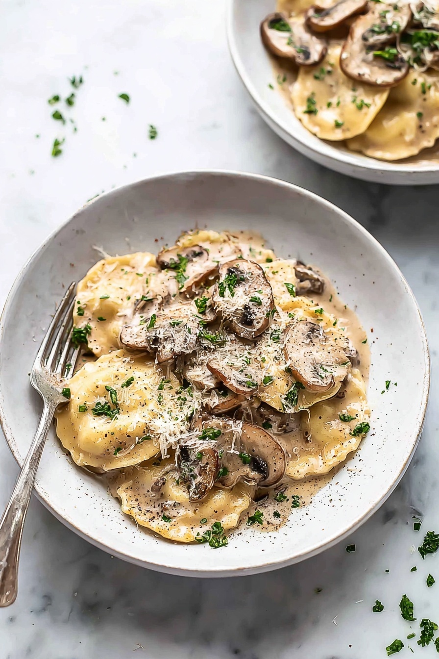 Creamy Mushroom Ravioli, Mushroom Ravioli Recipe, Easy Mushroom Pasta, Vegetarian Ravioli Dish, Comfort Food Pasta - The image shows a white bowl filled with two layers of round ravioli pasta covered in a creamy light brown mushroom sauce with visible slices of brown mushrooms on top and scattered parsley leaves for garnish. The sauce coats the pasta fully, giving a smooth, glossy texture, and there is a sprinkle of black pepper and grated cheese on top. A silver fork is placed on the left edge of the bowl resting against the side. In the background, there is a second bowl, similarly filled, placed on a white marbled surface with small bits of parsley scattered around. photo taken with an iphone --ar 2:3 --v 7