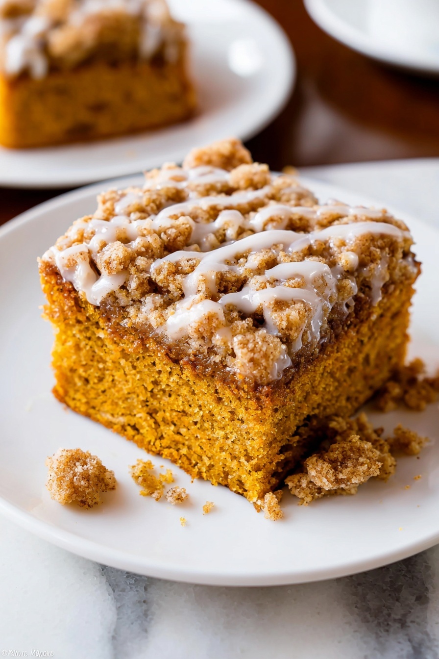 Pumpkin Crumb Coffee Cake, pumpkin coffee cake with crumb topping, fall coffee cake recipe, easy pumpkin coffee cake, moist pumpkin coffee cake - A close-up of a baked dessert square with two layers on a white plate with a raised dotted edge. The bottom layer is soft and moist, golden brown with a crumbly texture. The top layer is a thicker, crumbly streusel with a light brown color and a drizzle of white icing. A piece has been taken out with a silver fork resting on the plate holding some crumbs and icing. The plate sits on a white marbled surface. Photo taken with an iphone --ar 2:3 --v 7